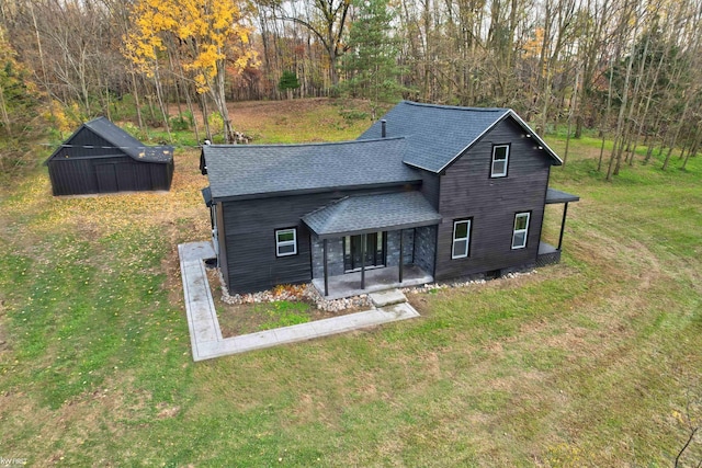 view of front of property with covered porch and a front yard