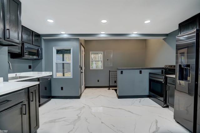 kitchen featuring electric panel, stainless steel appliances, and sink