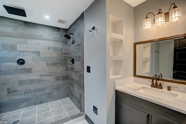 bathroom featuring vanity and tiled shower