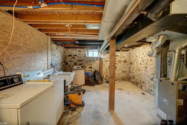 basement with independent washer and dryer, heating unit, and sink