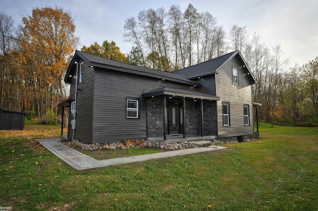 view of front of home featuring a front lawn and a sunroom