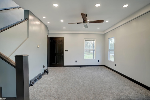 carpeted spare room with ceiling fan