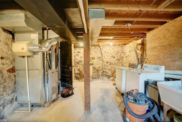 basement with sink and washing machine and clothes dryer