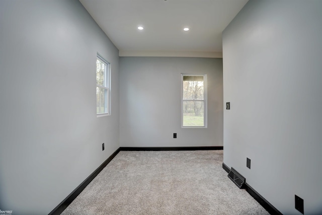 spare room with light colored carpet