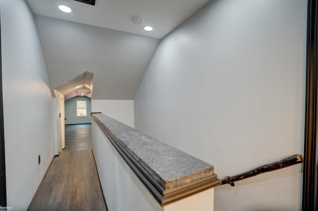 corridor featuring hardwood / wood-style floors and vaulted ceiling