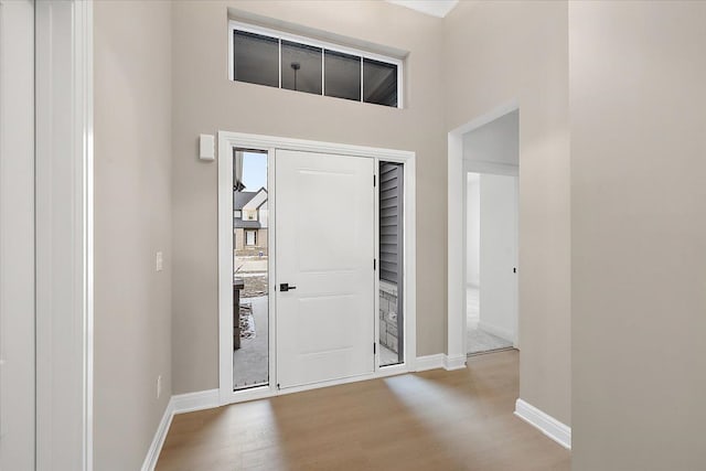 entrance foyer featuring a high ceiling and light hardwood / wood-style flooring