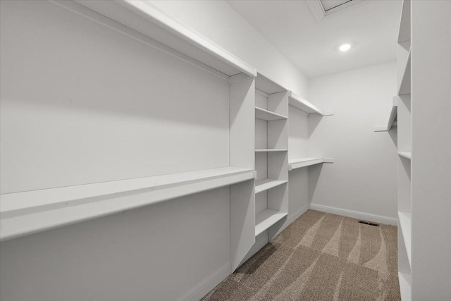 walk in closet featuring dark colored carpet