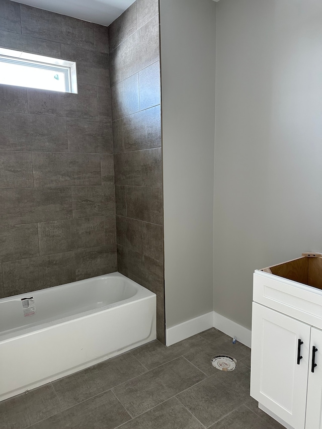 bathroom featuring tub / shower combination and tile patterned flooring