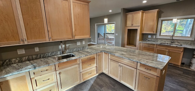 kitchen featuring pendant lighting, kitchen peninsula, and sink