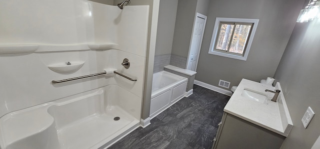 bathroom with vanity and shower with separate bathtub