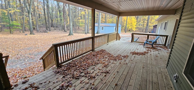 wooden terrace featuring a storage unit