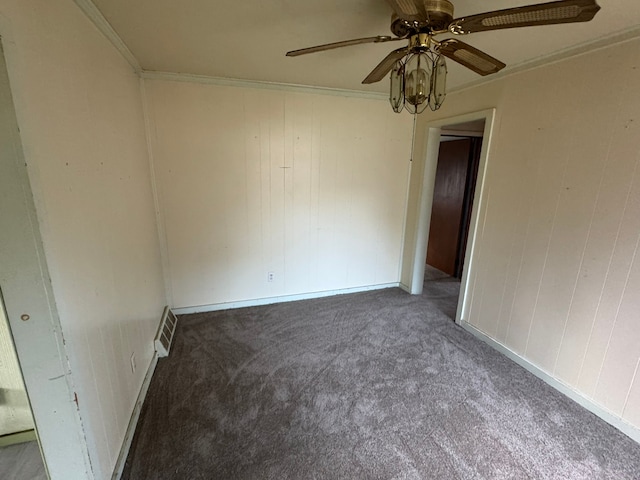 carpeted spare room featuring ceiling fan and crown molding