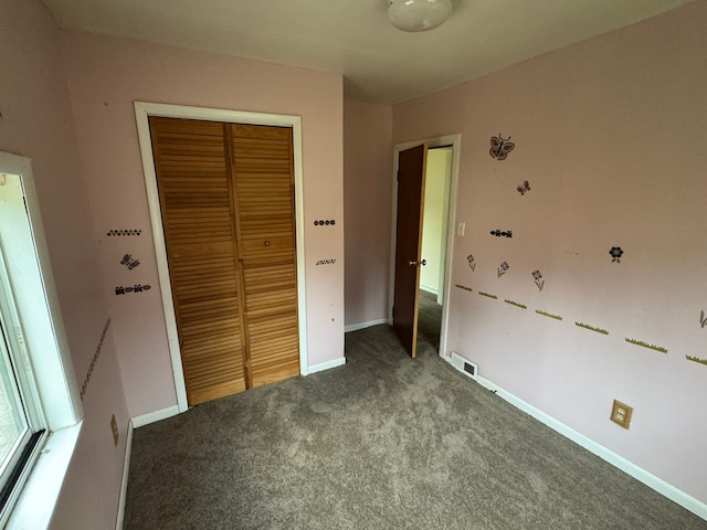 unfurnished bedroom with carpet and a closet