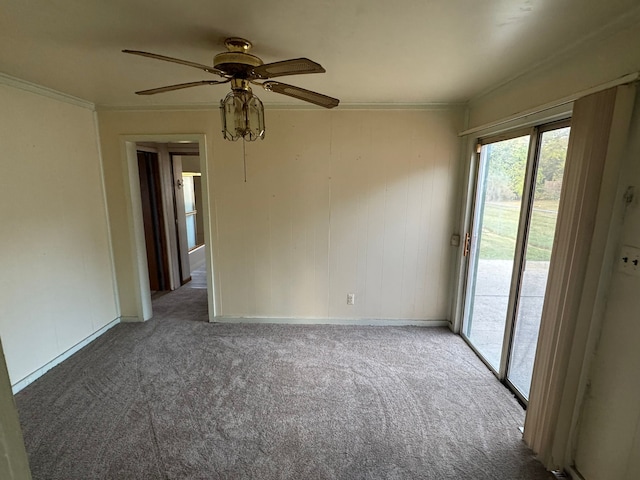 unfurnished room featuring dark colored carpet, ceiling fan, and crown molding