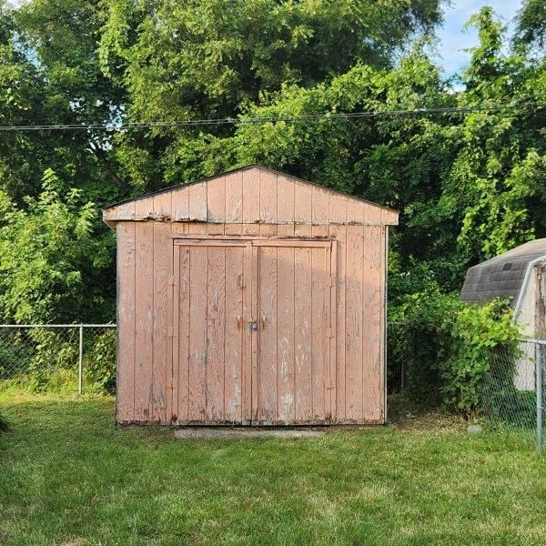 view of outbuilding featuring a yard