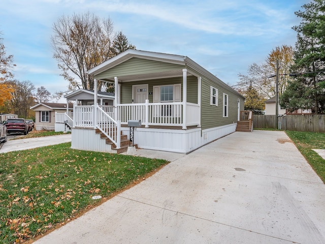 view of front of property with covered porch and a front lawn