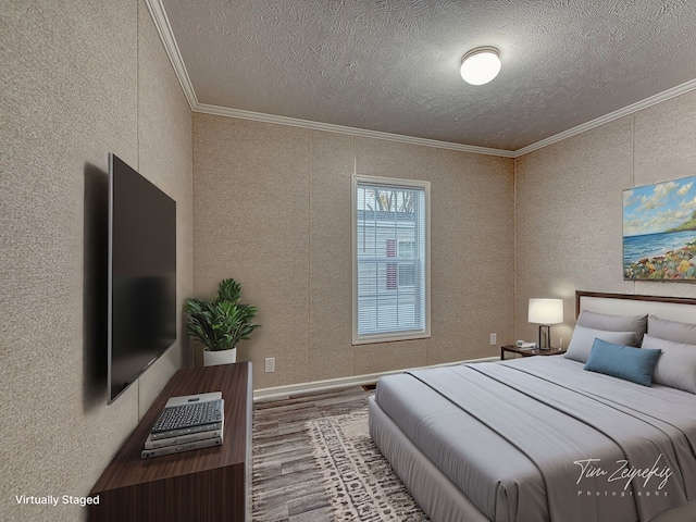 bedroom featuring hardwood / wood-style floors, crown molding, and a textured ceiling