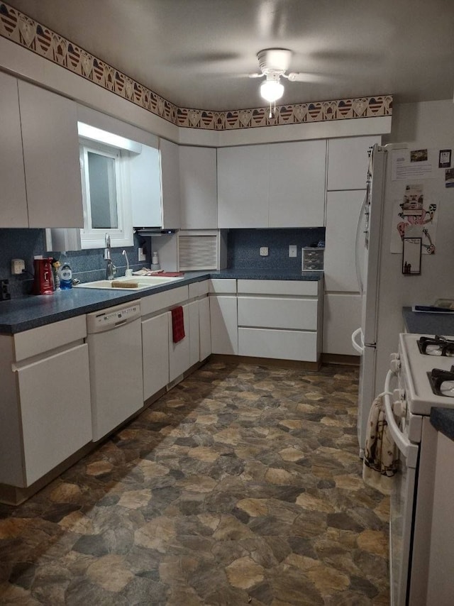 kitchen with tasteful backsplash, sink, white cabinets, and white appliances