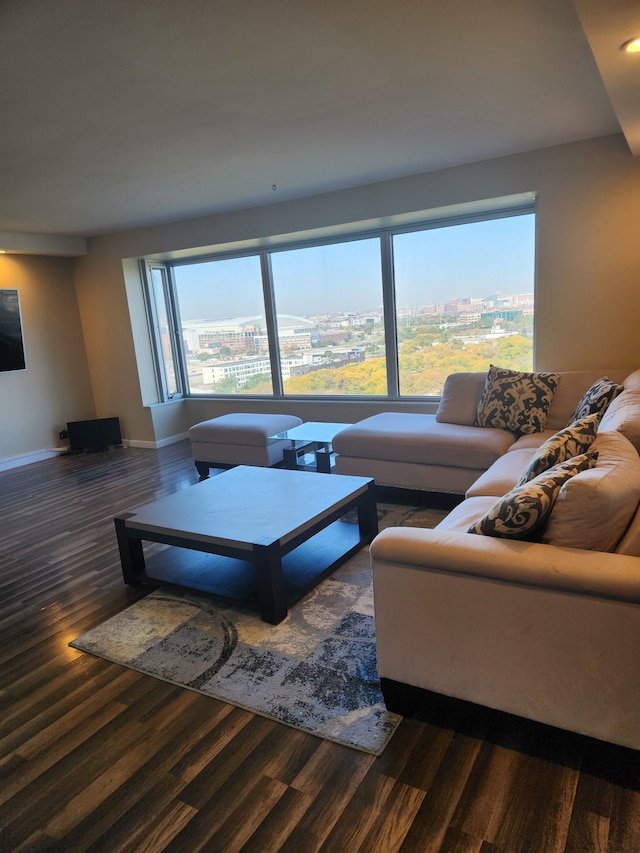 living room featuring plenty of natural light and dark hardwood / wood-style flooring