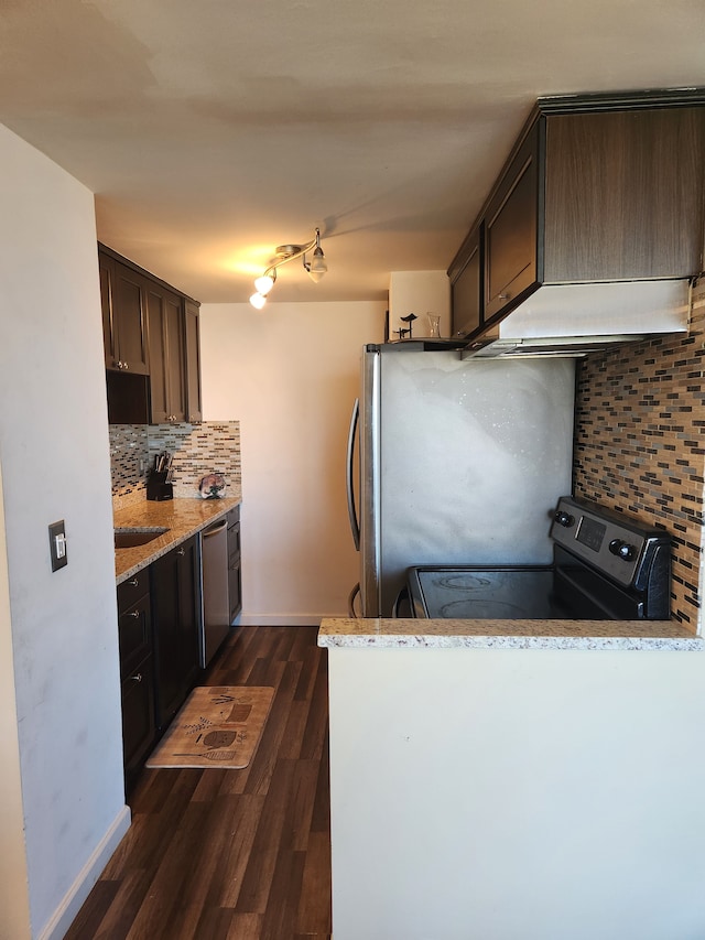 kitchen with light stone countertops, stainless steel appliances, dark hardwood / wood-style floors, backsplash, and dark brown cabinets