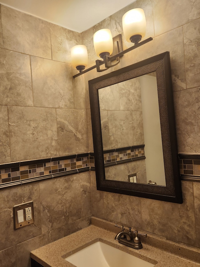 bathroom featuring vanity and tile walls