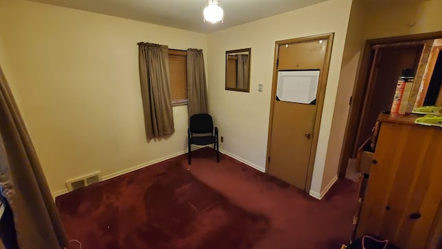 living area featuring dark colored carpet