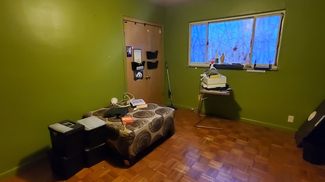 bedroom featuring parquet flooring