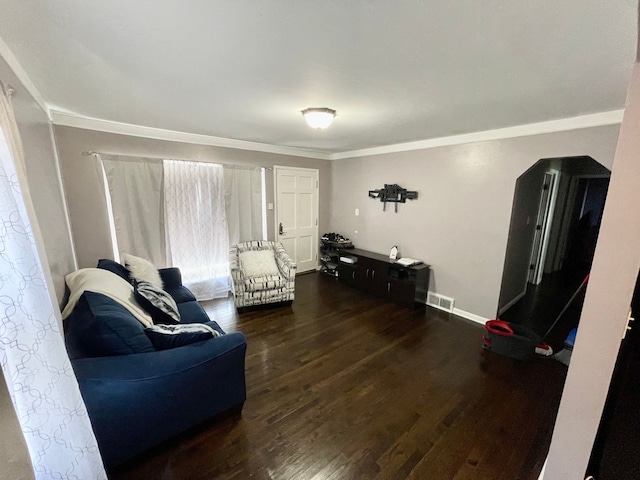 living room with dark hardwood / wood-style floors and ornamental molding