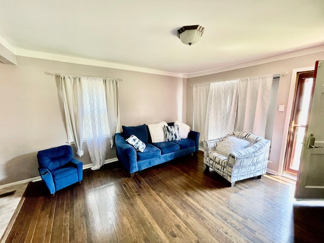 living room with dark hardwood / wood-style floors and ornamental molding