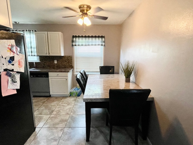 kitchen featuring dishwasher, a healthy amount of sunlight, backsplash, fridge, and white cabinets