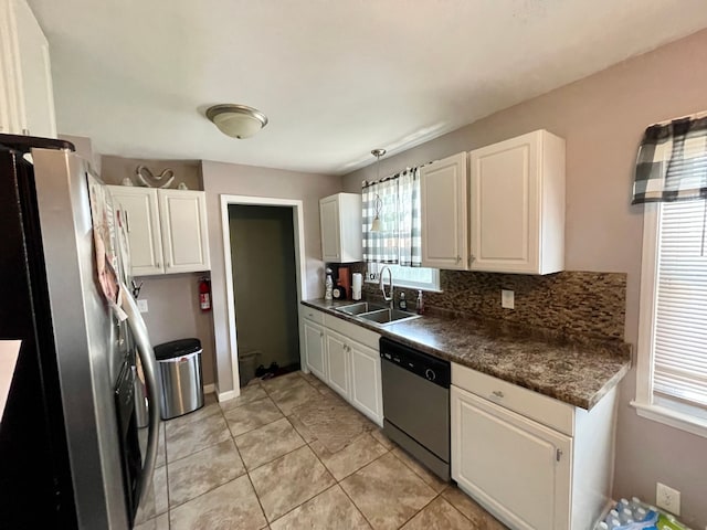 kitchen with backsplash, white cabinets, sink, light tile patterned floors, and stainless steel appliances