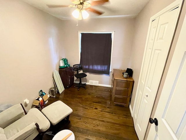 living room with dark hardwood / wood-style flooring and ceiling fan