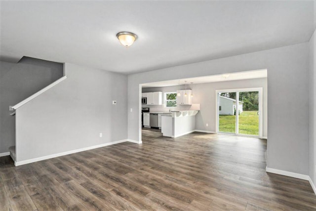 unfurnished living room with dark wood-type flooring