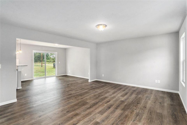 empty room with dark hardwood / wood-style flooring