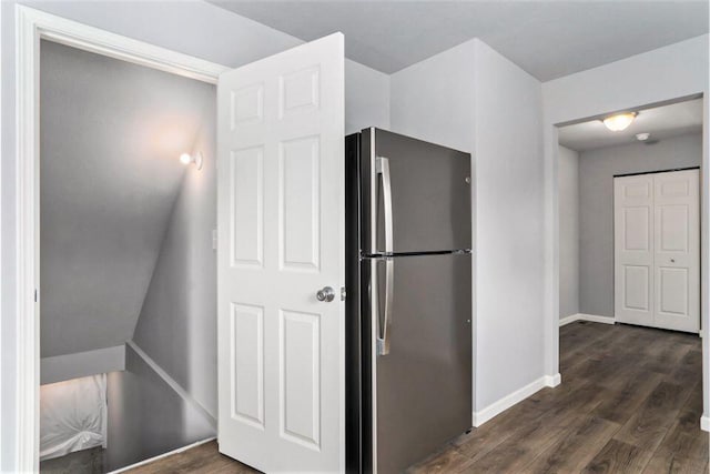 kitchen featuring stainless steel fridge and dark wood-type flooring