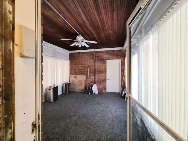 unfurnished sunroom with ceiling fan and wooden ceiling