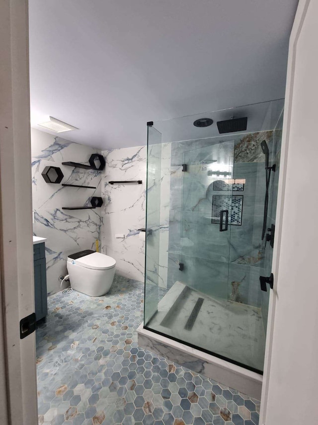 bathroom with vanity, toilet, a shower with door, and tile walls