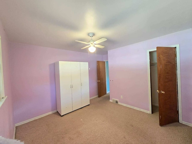 unfurnished bedroom featuring ceiling fan and light colored carpet