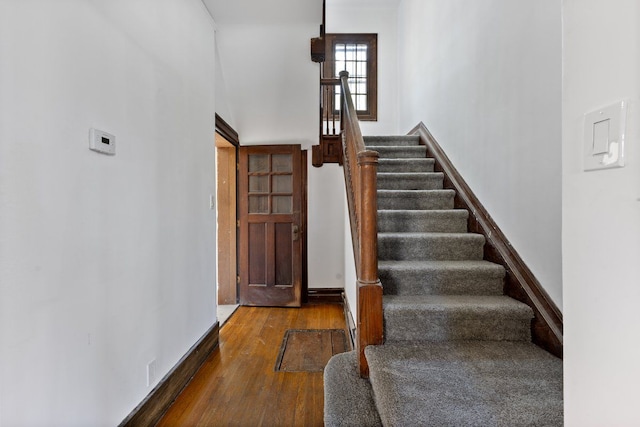 stairs featuring hardwood / wood-style floors