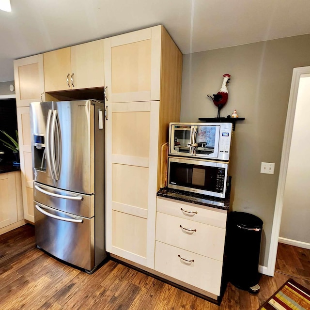 kitchen with dark hardwood / wood-style flooring and appliances with stainless steel finishes