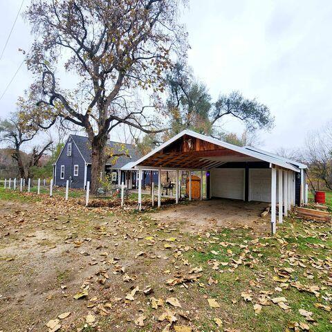 view of front of home featuring an outbuilding and a carport