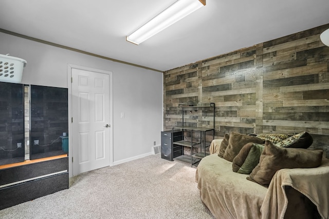 carpeted living room with wood walls and crown molding