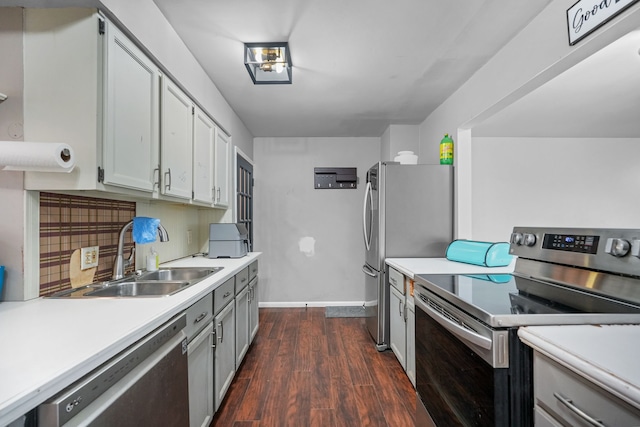 kitchen featuring dark hardwood / wood-style flooring, stainless steel appliances, and sink