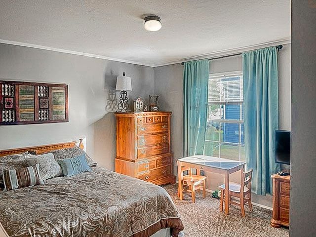 carpeted bedroom featuring a textured ceiling