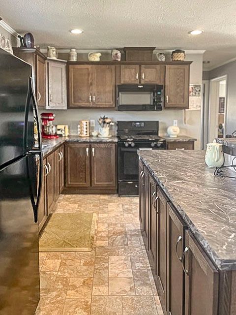 kitchen featuring dark stone countertops, dark brown cabinets, black appliances, and a textured ceiling