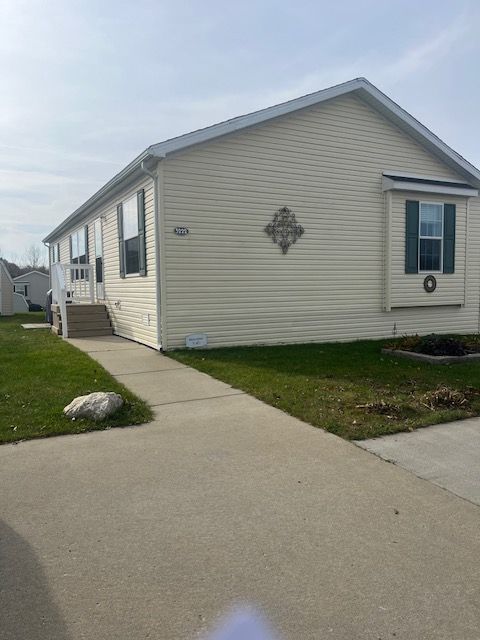 view of side of home with a lawn