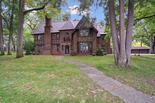 tudor house with a garage and a front yard