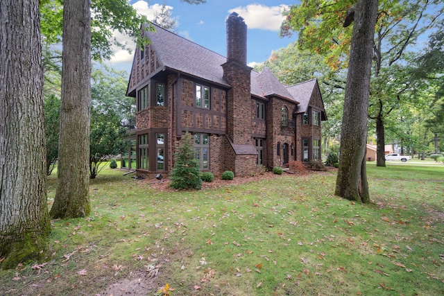 view of side of home with a lawn