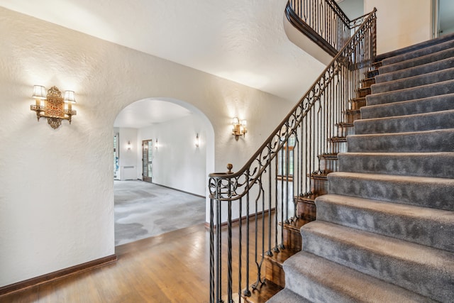 staircase featuring wood-type flooring