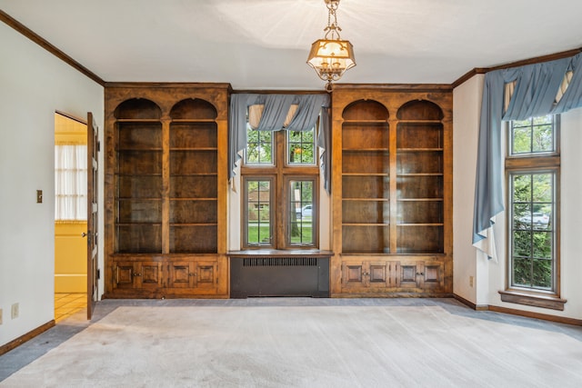 unfurnished living room with carpet flooring, crown molding, and radiator